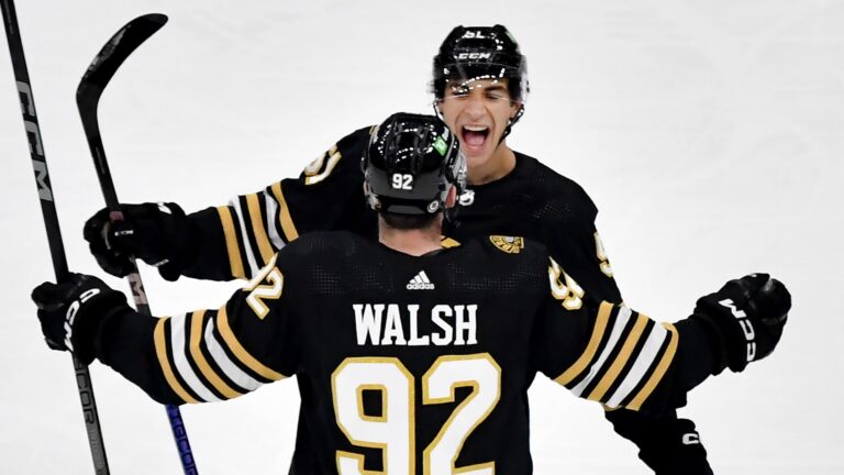 Boston Bruins’ Matthew Poitras and Reilly Walsh celebrate Poitras’ goal during the first period of an NHL exhibition game at TD Garden in Boston, Sunday, Sept. 24, 2023