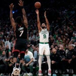 Boston Celtics guard Derrick White (9) puts up a three over Miami Heat guard Kyle Lowry (7) during the fourth quarter. - The Boston Celtics host the Miami Heat in the team’s home season opener on October 27, 2023 at TD Garden in Boston, MA.