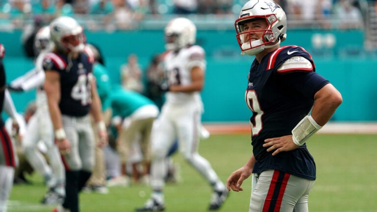 New England Patriots quarterback Mac Jones (10) looks at the scoreboard replay after the Patriots last play. - The Miami Dolphins host the New England Patriots on October 29, 2023 at Hard Rock Stadium in Miami Gardens, FL.