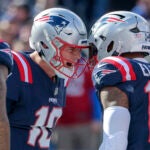 New England Patriots quarterback Mac Jones celebrates his teammate Ezekiel Elliott’s touchdown run against the Buffalo Bills during first quarter NFL action at Gillette Stadium.