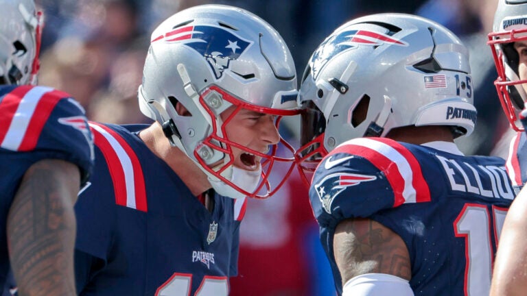 New England Patriots quarterback Mac Jones celebrates his teammate Ezekiel Elliott’s touchdown run against the Buffalo Bills during first quarter NFL action at Gillette Stadium.