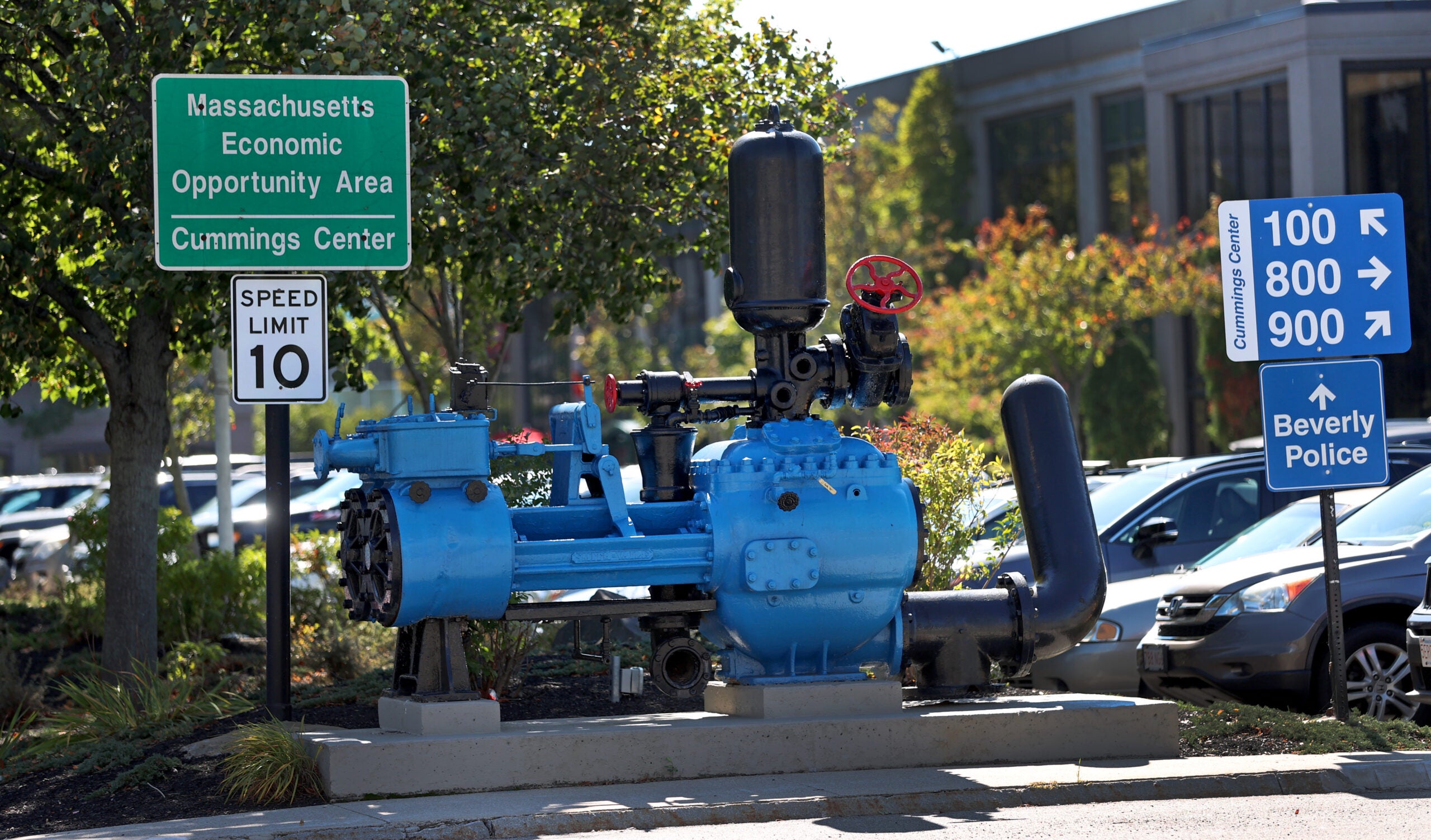 Directional signs with a piece of factory machinery from the shoe factory at an intersection at the complex.