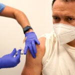 Julio Figuera, 43, receives a vaccine at the Cook County, Ill., medical clinic.