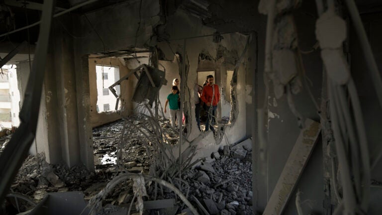 Palestinians look at the apartment of Khaled Kharousha that was destroyed by the Israeli military in Nablus, West Bank.