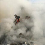 Palestinian firefighters extinguish fire caused by an Israeli airstrike in Khan Younis refugee camp.