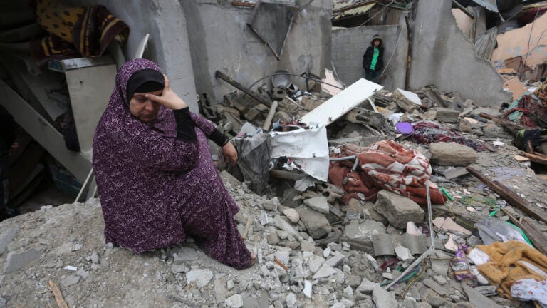 Palestinians look at destruction after Israeli strikes on Rafah, Gaza Strip.
