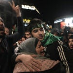 Omar Atshan, 17, is hugged by his mother after being released from an Israeli prison in the West Bank town of Ramallah.