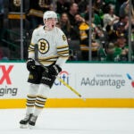 Boston Bruins defenseman Mason Lohrei reacts after scoring a goal against the Dallas Stars during the first period of an NHL hockey game, Monday, Nov. 6, 2023, in Dallas.