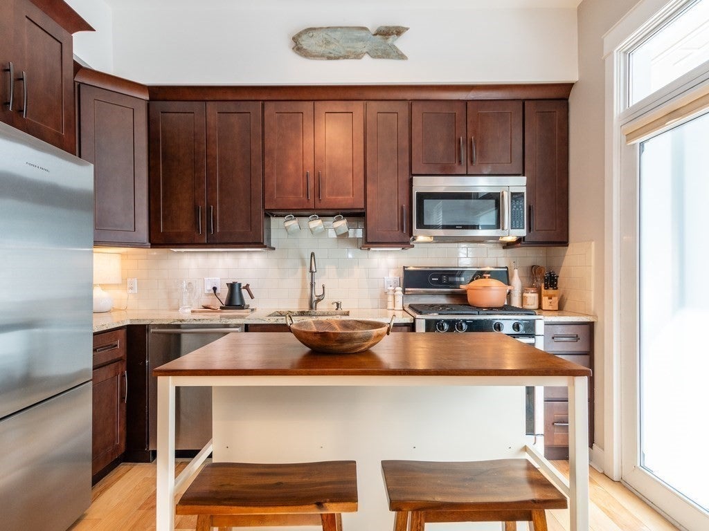 Kitchen with an island and dark wood cabinets. 