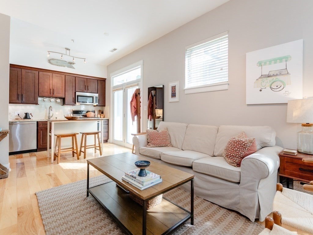 Living room and kitchen with wood floors. 