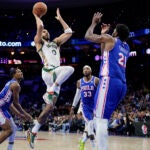 The Celtics' Jayson Tatum goes up for a shot against Philadelphia's Joel Embiid during the second half.