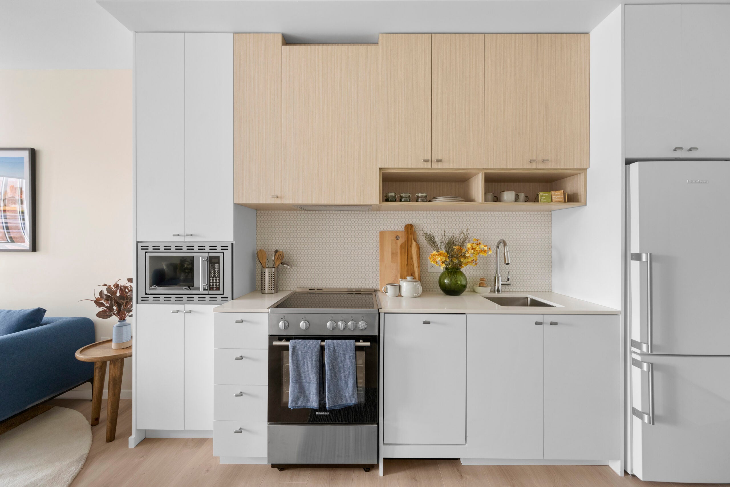 Kitchen with white cabinets in new Quincy Center apartment complex.