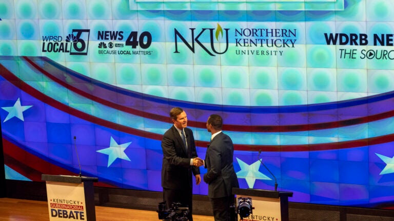 Democratic Gov. Andy Beshear, left, and Republican Attorney General Daniel Cameron shake hands in Kentucky.