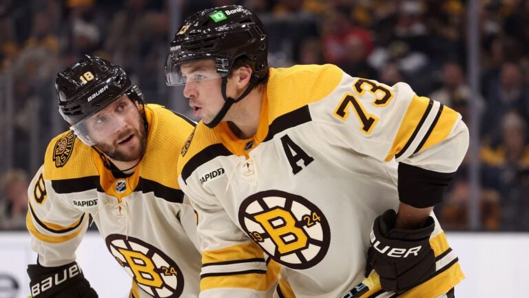 BOSTON, MASSACHUSETTS - NOVEMBER 18: Pavel Zacha #18 of the Boston Bruins talks with Charlie McAvoy #73 during the second period against the Montreal Canadiens at TD Garden on November 18, 2023 in Boston, Massachusetts.