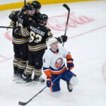 Bruins center Charlie Coyle, left, celebrates his goal with Pavel Zacha, top, and Brad Marchand during the second period.