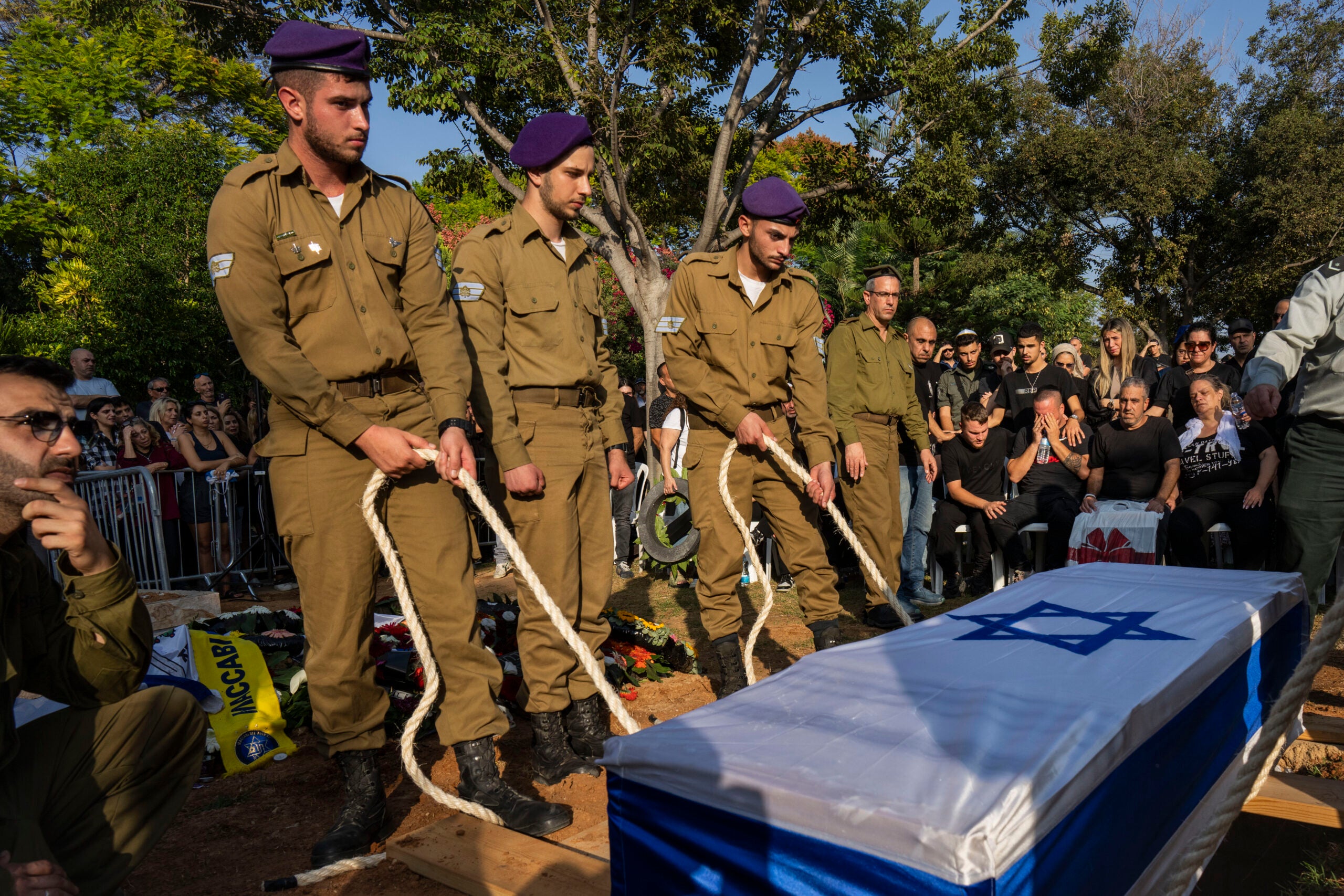 Israeli soldiers lower the coffin of late Israeli Staff Sergeant Shay Arvas at the Holon military cemetery, outskirts of Tel Aviv, Israel. 
