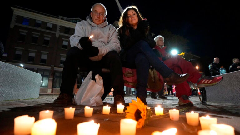Community members gather during a candlelight vigil in Auburn, Maine.
