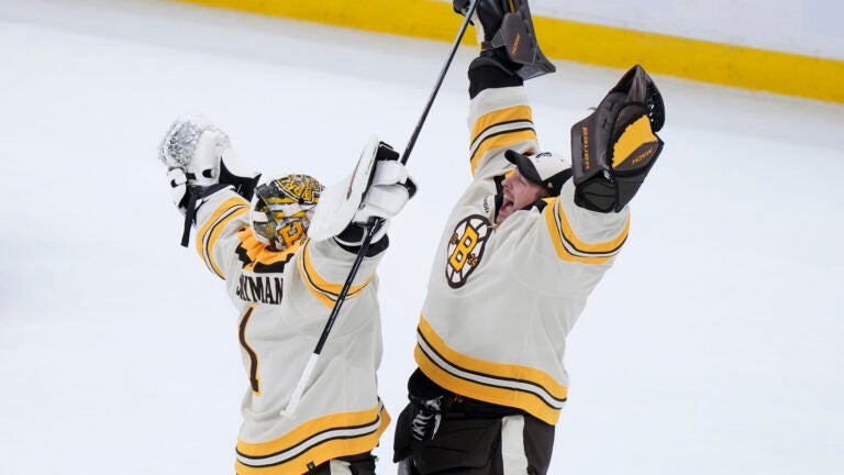 Boston Bruins goaltenders Jeremy Swayman, left, and Linus Ullmark, right, celebrate after they defeated the Toronto Maple Leafs in a shootout during an NHL hockey game, Thursday, Nov. 2, 2023, in Boston.