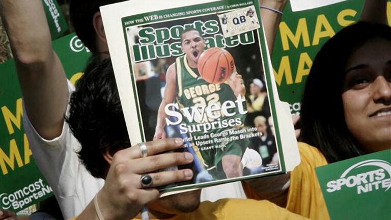 A George Mason University fan holds up a Sports Illustrated magazine at a send off for the team.