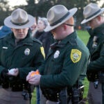 New Hampshire State Troopers Thomas Sandberg, left, and Josh Farmer participate in a candlelight vigil on Monday evening.