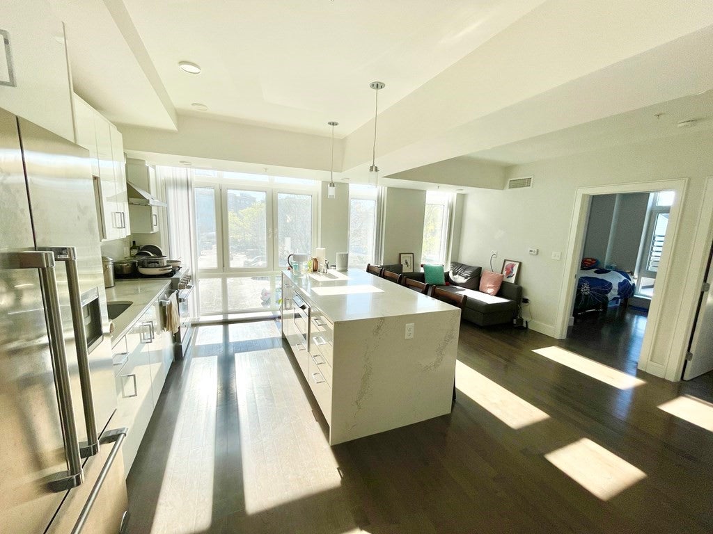 Cambridge apartment with wood floors, modern kitchen, and large windows. 