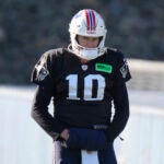 New England Patriots quarterback Mac Jones (10) warms up during an NFL football practice, Wednesday, Nov. 29, 2023, in Foxborough, Mass.