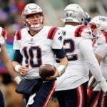 New England Patriots quarterback Mac Jones (10) walks back to the line of scrimmage after being sacked by the New York Giants during the first quarter of an NFL football game, Sunday, Nov. 26, 2023, in East Rutherford, N.J.