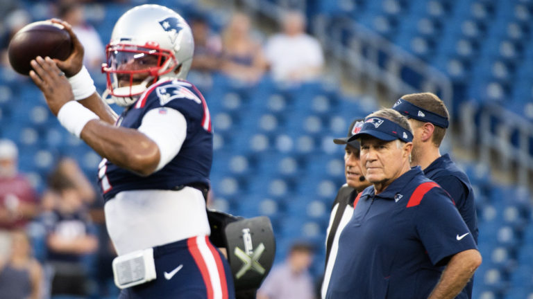 New England Patriots head coach Bill Belichick watches Cam Newton #1 during warm ups prior to the start of the game against the Washington Football Team at Gillette Stadium on August 12, 2021 in Foxborough, Massachusetts.