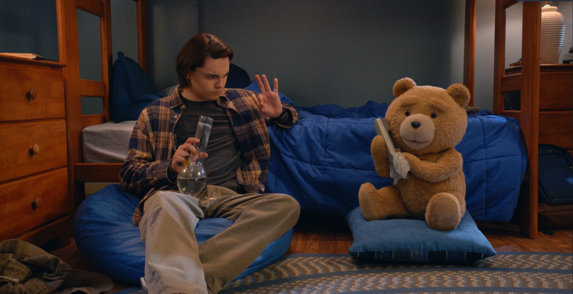 Max Burkholder and Seth MacFarlane in the Peacock prequel series "Ted."