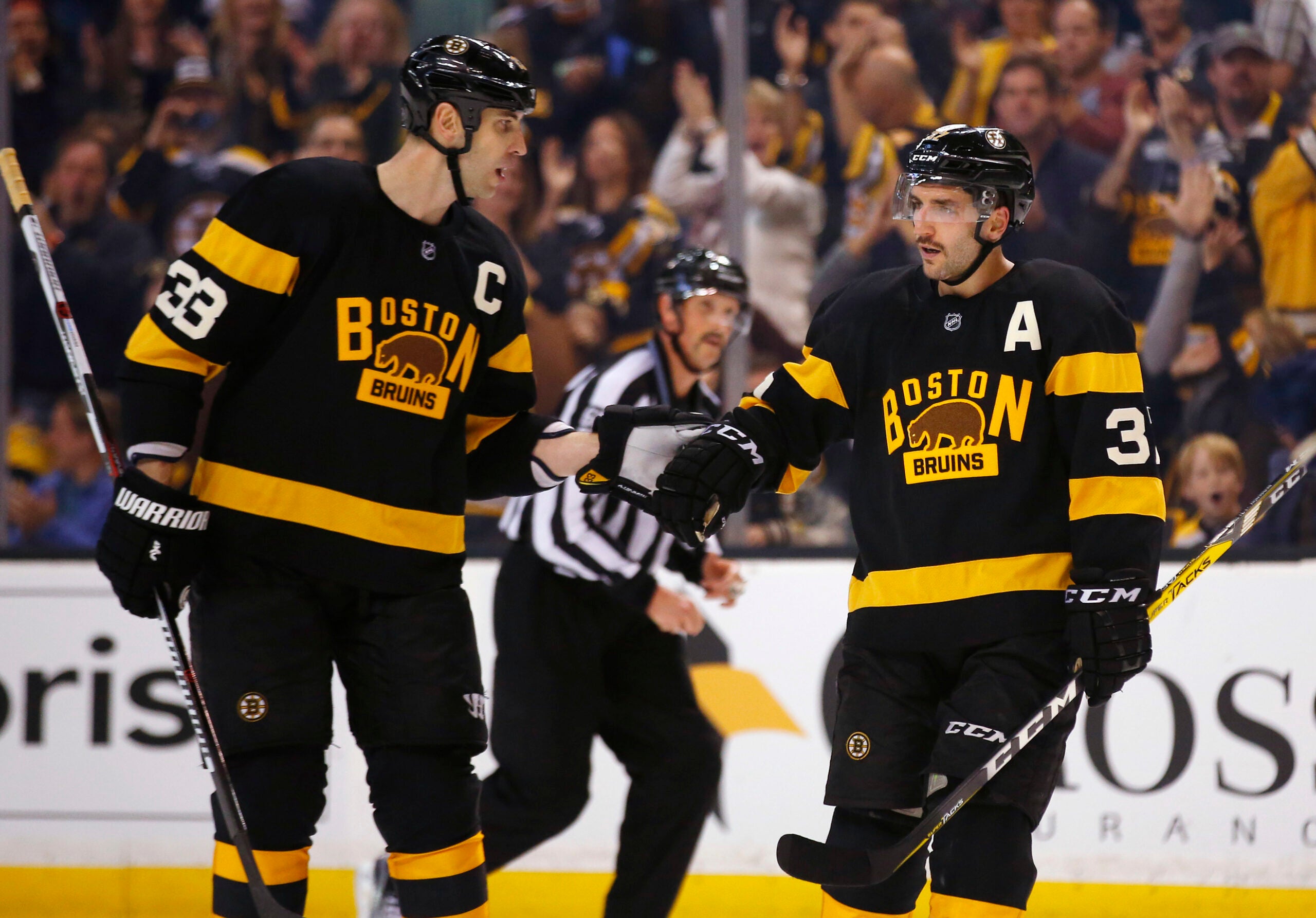 Boston Bruins' Patrice Bergeron is congratulated, after his goal, by defenseman Zdeno Chara (33) during the second period of an NHL hockey game against the Winnipeg Jets in Boston on Saturday, Nov. 19, 2016.