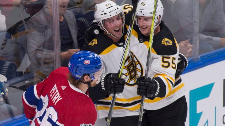 Boston Bruins forward Tim Schaller (59) is congratulated by forward Noel Acciari after he scored as Montreal Canadiens Jeff Petry skates by during the second period of a preseason NHL hockey game, Monday, Sept. 18, 2017, in Quebec City, Quebec.