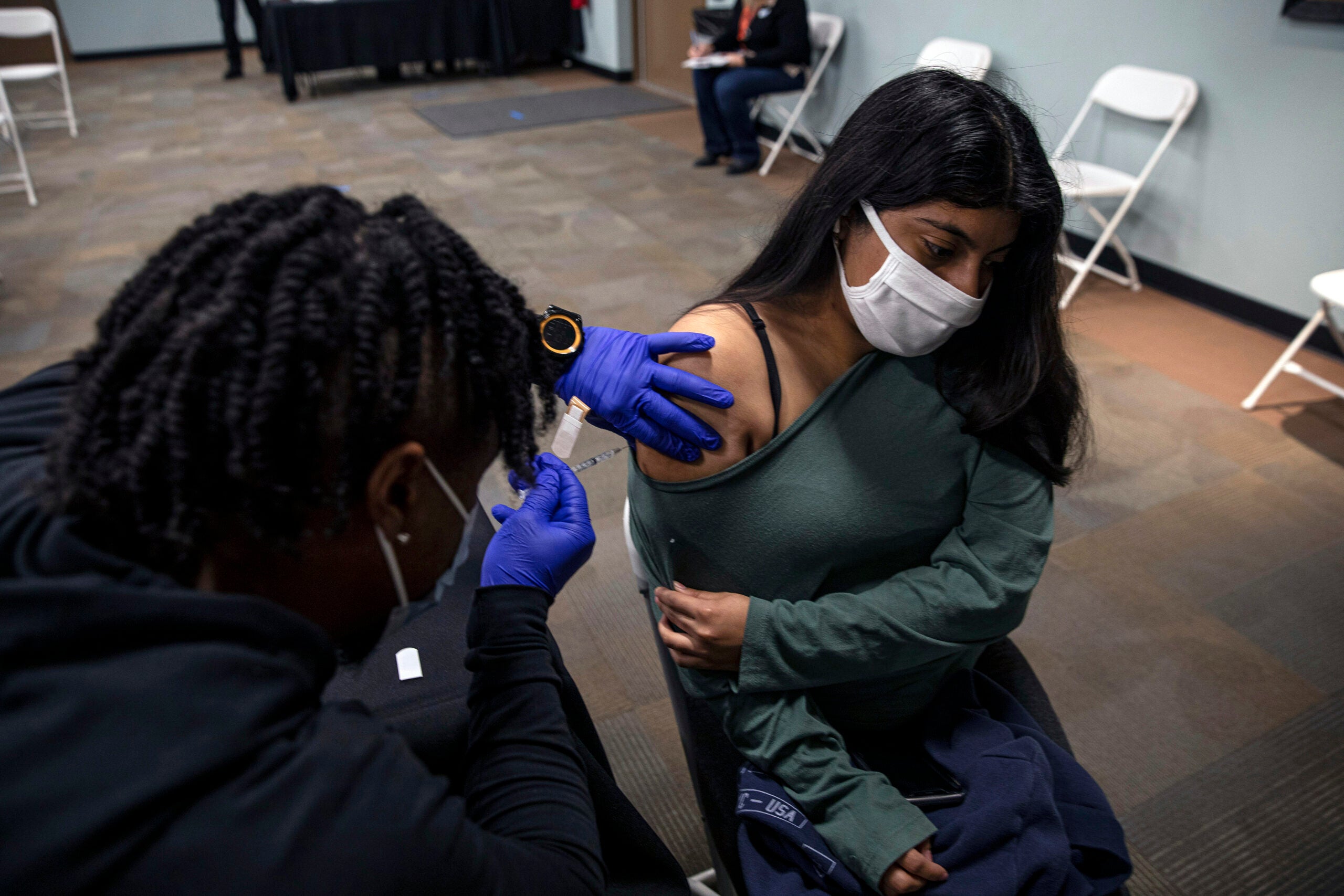 A patient receives her second dose of COVID-19 vaccine in Phoenix, Ariz.