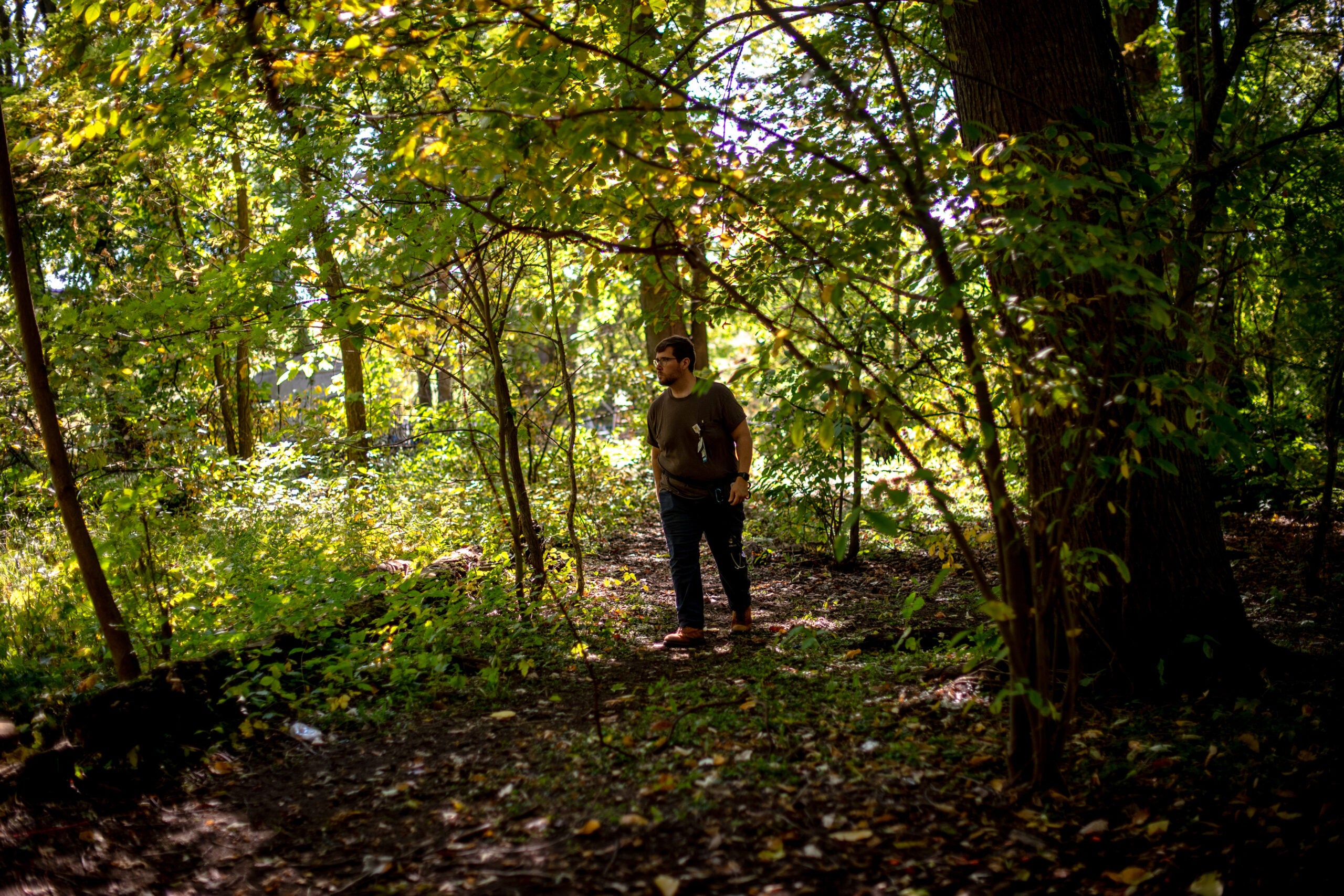 Dr. Nic Helmstetter walks to see patients at a homeless encampment outside Kalamzoo, Mich.