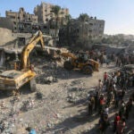 Heavy equipment is used to inspect the site of an Israeli strike in Khan Younis.