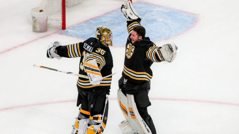 Boston Bruins starting goaltender Linus Ullmark (35) celebrates with his teammate goaltender Jeremy Swayman (1) after they defeated the Florida Panthers 4-3 during overtime period NHL action at TD Garden.