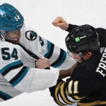 Boston Bruins center Trent Frederic (11) fights Sharks Givani Smith in the 2nd period.
