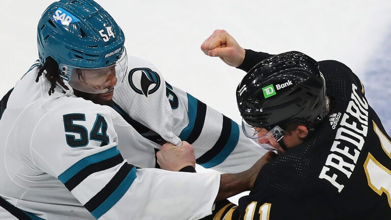 Boston Bruins center Trent Frederic (11) fights Sharks Givani Smith in the 2nd period.