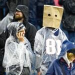 FOXBOROUGH, MASSACHUSETTS - DECEMBER 03: A New England Patriots fan wearing a paper bag looks on during the game between the Los Angeles Chargers and the New England Patriots at Gillette Stadium on December 03, 2023 in Foxborough, Massachusetts.