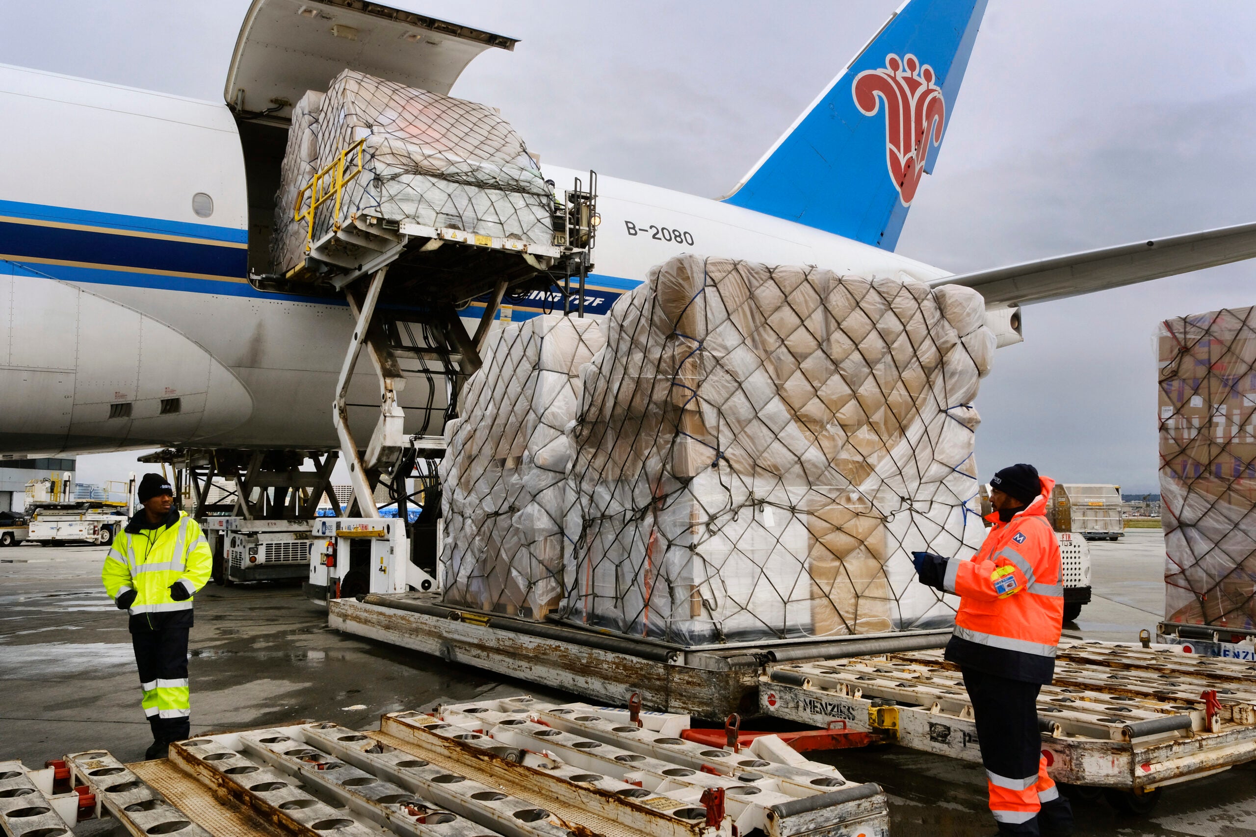 Ground crew at the Los Angeles International airport unload pallets of supplies. 