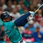 Seattle Mariners' Teoscar Hernandez follows through in a baseball game against the Los Angeles Angels, Tuesday, Sept. 12, 2023, in Seattle.