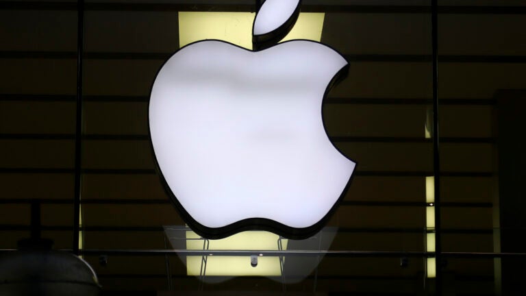 FILE - The Apple logo is illuminated at a store in the city center of Munich, Germany, Dec. 16, 2020.