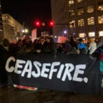Protesters calling for an Israeli ceasefire in Gaza block an intersection in Boston.