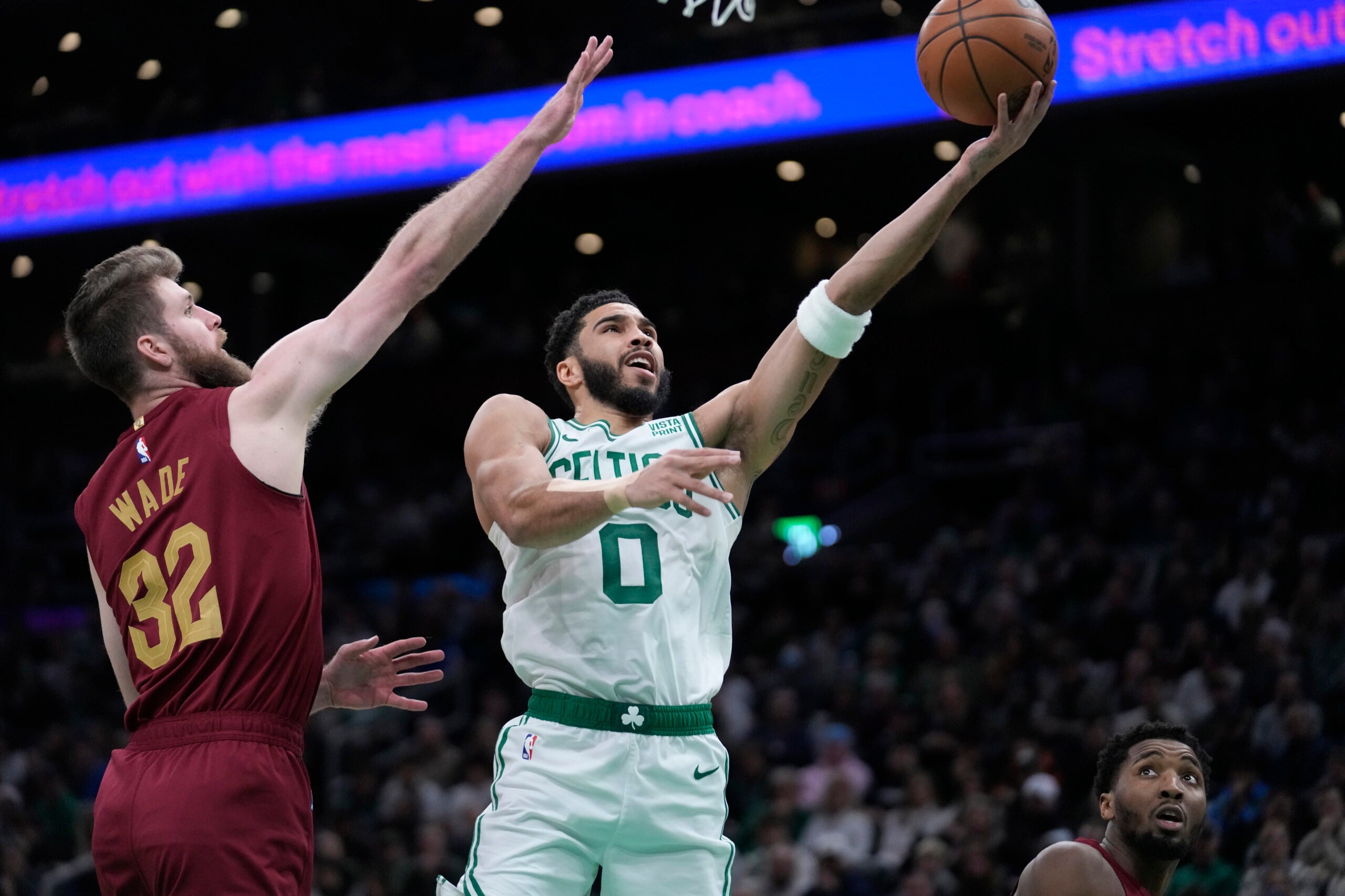 Celtics forward Jayson Tatum shoots at the basket as Cleveland Cavaliers forward Dean Wade defends in the first half.