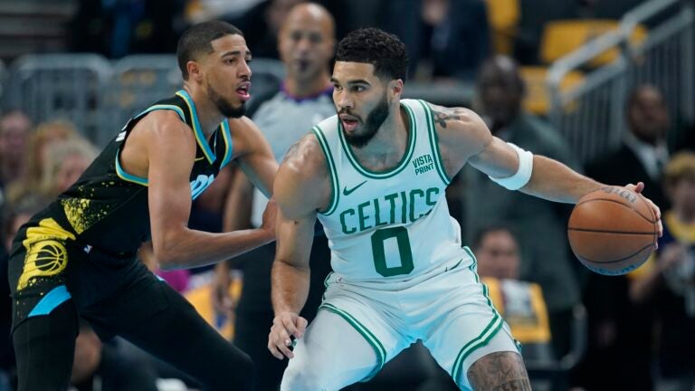 Boston Celtics' Jayson Tatum, right, is defended by Indiana Pacers' Tyrese Haliburton, left, during the first half half of an NBA basketball In-Season Tournament game, Monday, Dec. 4, 2023, in Indianapolis.