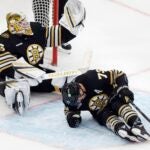 Boston Bruins' Charlie McAvoy (73) lies on the ice after colliding with Boston Bruins' Linus Ullmark (35) during the third period of an NHL hockey game against the New Jersey Devils, Saturday, Dec. 30, 2023, in Boston.