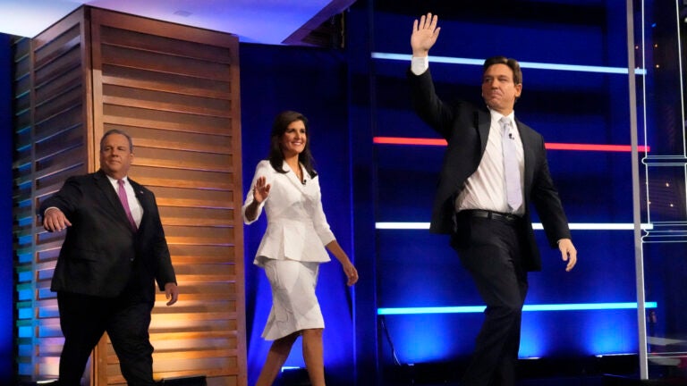 Republican presidential candidates from left, former New Jersey Gov. Chris Christie, former UN Ambassador Nikki Haley, and Florida Gov. Ron DeSantis, arrive on stage before a Republican presidential primary debate.