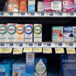 A selection of eye drops line a shelf at a pharmacy in Los Angeles.