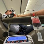 Aaron Posey, a Bloodworks Northwest executive, donates blood at the blood center's Seattle headquarters.