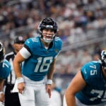 Jacksonville Jaguars quarterback Nathan Rourke (18) gives instructions to his team during the second half of an NFL preseason football game against the Dallas Cowboys, Saturday, Aug. 12, 2023, in Arlington, Texas.