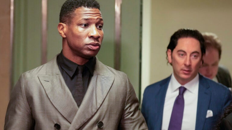 Jonathan Majors, left, enters a courtroom at the Manhattan criminal courts in New York, Monday, Dec. 18, 2023.